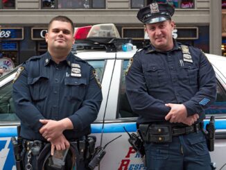 2 new york cops leaning against a car before rushing in and doing something stupid