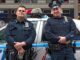 2 new york cops leaning against a car before rushing in and doing something stupid