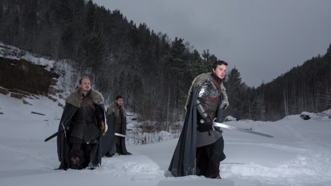 Medieval knights with sword in armor as style Game of Thrones finale going in Winter Rock Landscapes