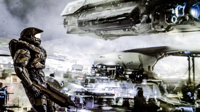The Master Chief, not dressed in any Halo Infinite multiplayer customisation options, against the background of some spaceships