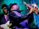A man playing guitar and another on saxaphone in a funk band similar to those available in Far Cry 6