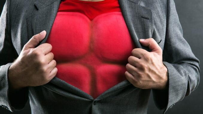 man opening his shirt to reveal a bullet-proof vest