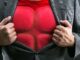 man opening his shirt to reveal a bullet-proof vest