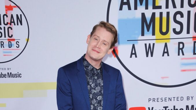 Macauley Culkin who may be starring in the new home alone reboot smiling with head tilted