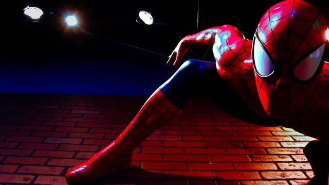 a close-up of spiderman on the side of a wall in the new spiderman trailer