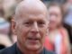 A headshot of Bruce Willis with a blurred crowd behind him, possibly after having made a terrible action movie