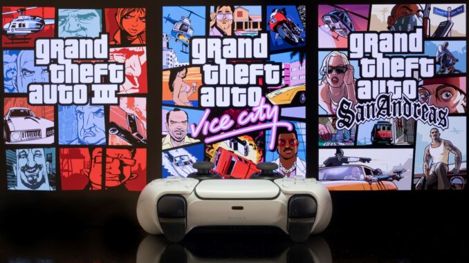 A playstation 5 controller, infront of the covers for each GTA game. GTA trilogy bug