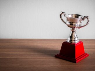 cheap looking trophy with red base on table. Next year's golden globes