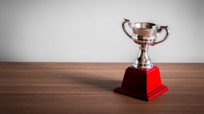 cheap looking trophy with red base on table. Next year's golden globes