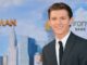 Tom Holland in front of spiderman poster. Control Nate