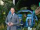 Chris Pratt voice standing in front of a set from Jurassic world