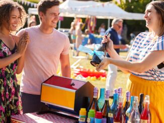 Couple winning a prize at a tombola at a village fete