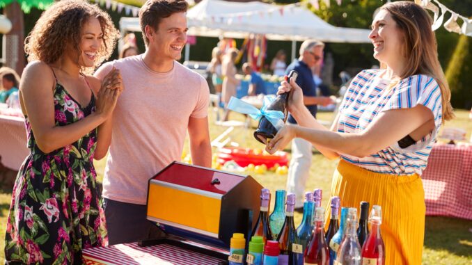 Couple winning a prize at a tombola at a village fete