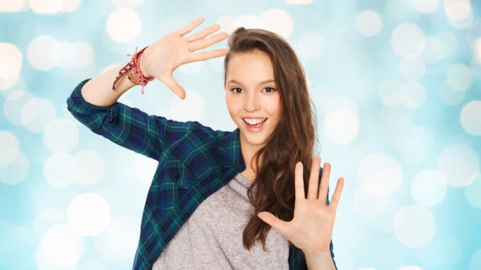 a teenage girl in blue shirt throwing a kooky pose. Young Adult Novel
