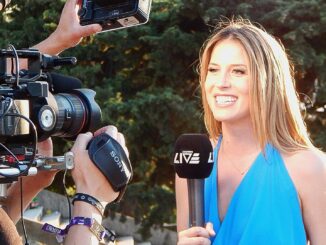 A Local News programmes female reporter in blue dress reporting to cameras