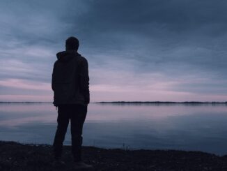 lonely man Not seen Top Gun: Maverick looks out over sea at dusk