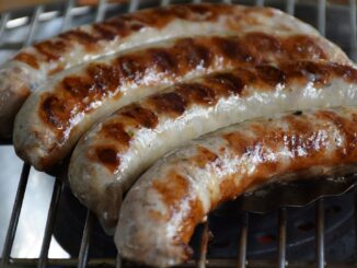 4 sausages on a grill. Gorr the God Butcher