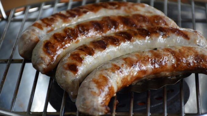 4 sausages on a grill. Gorr the God Butcher