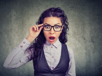 A woman in glasses looking shocked. post-credit scene