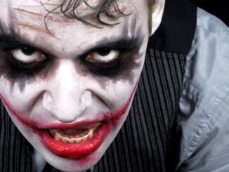 Close up on joker sequel face. He's got a mad smile.