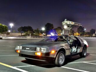 the delorean from back to the future sequel in the car park with door open