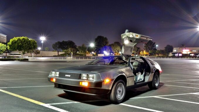 the delorean from back to the future sequel in the car park with door open