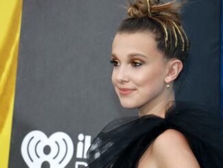 millie bobby brown in black dress from shoulders up. Enola Holmes 2