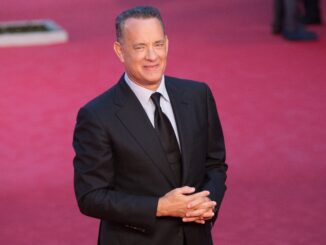 tom hanks in black suit on purple background
