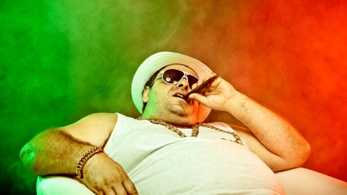 crime boss in undershirt. Smokey background. I like your balls
