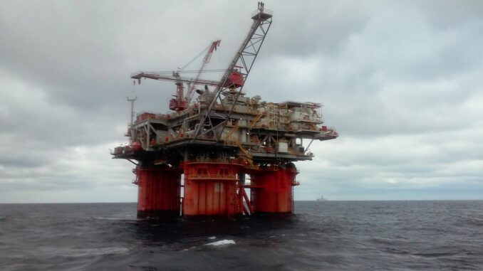 A christmas oil rig in the ocean with red columns