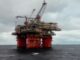 A christmas oil rig in the ocean with red columns