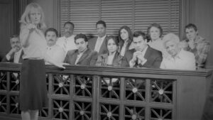 Portrait of a female advocate pointing with jurors sitting together in the witness stand at court house. 12 Angry Men.