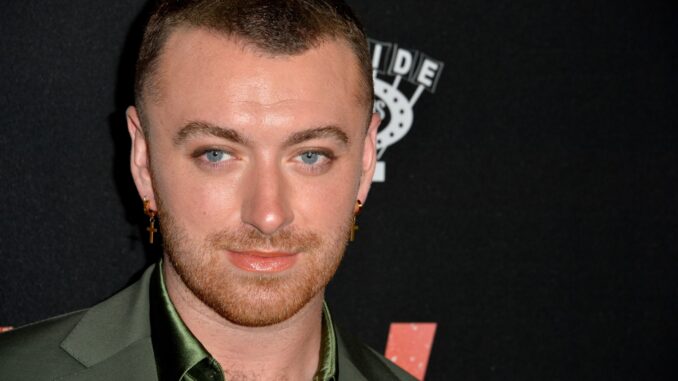 Sam Smith headshot wearing green shirt. Sexually provocative video