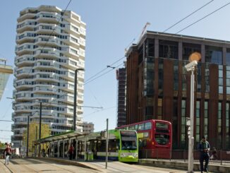 Croydon, UK - October 2, 2019: Travellers using the various transport offerings outside East Croydon railway station on a sunny autumn day in South London. Gritty new Star Wars