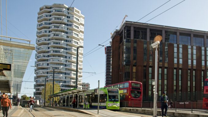 Croydon, UK - October 2, 2019: Travellers using the various transport offerings outside East Croydon railway station on a sunny autumn day in South London. Gritty new Star Wars