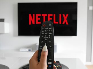 A remote control in front of a tv with netflix cancelled on