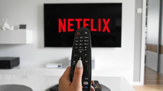 A remote control in front of a tv with netflix cancelled on