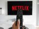 A remote control in front of a tv with netflix cancelled on