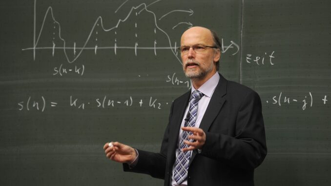 a bald professor in front of a blackboard explaining something . lady ghostbusters