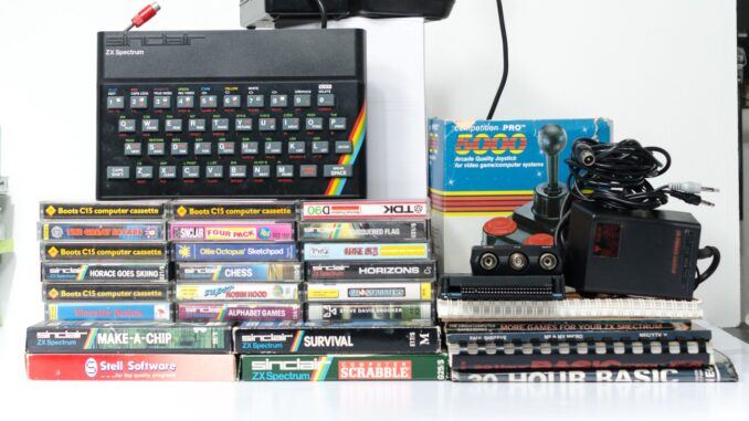 A retro vintage nostalgic sinclair zx spectrum 48k 1980s computer console with games and retro joystick controllers on a white background. Jet Set Willy series
