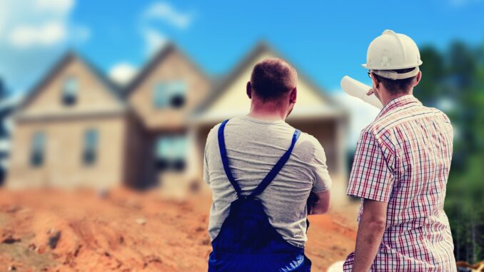Two builders pointing at house holding some plans. tv show about houses