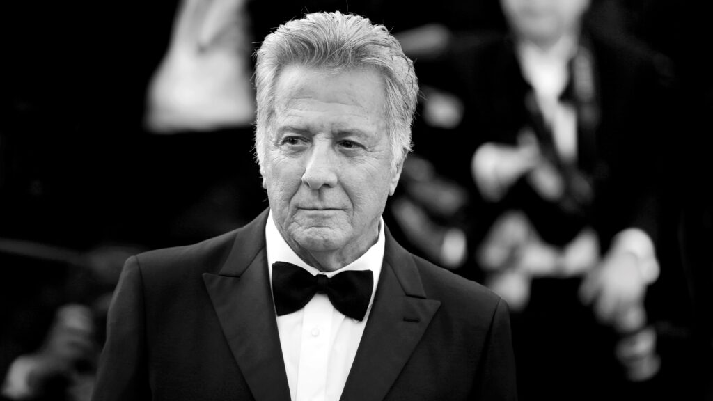 Dustin Hoffman, in front of a crowd wearing a dinner suit