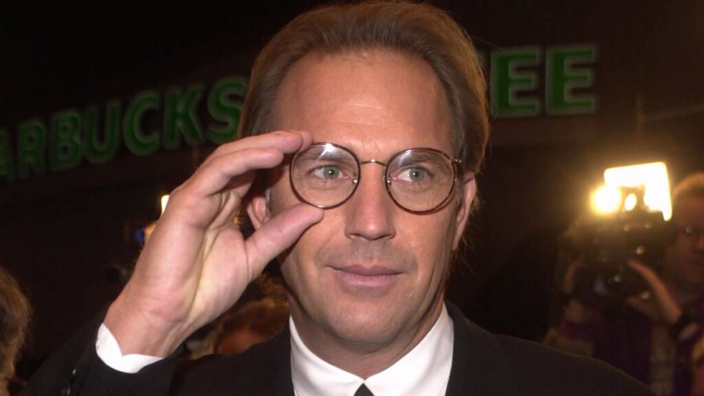 Kevin Costner, adjustig round spectacles. Porbably from the 90s. JFK
