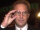 Kevin Costner, adjustig round spectacles. Porbably from the 90s. JFK