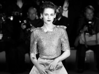 Black and White picture of Kristen Stewart. Formal dress. In front of a crowd