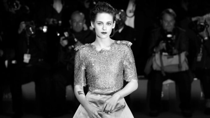 Black and White picture of Kristen Stewart. Formal dress. In front of a crowd