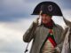 An actor playing napoleon trailer salutes the camera